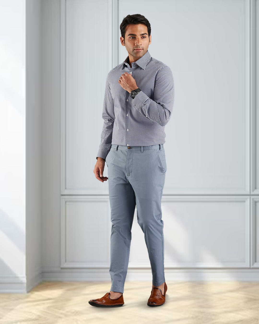 Front view of model wearing custom Genoa Chino pants for men by Luxire in soft blue grey hand at chest
