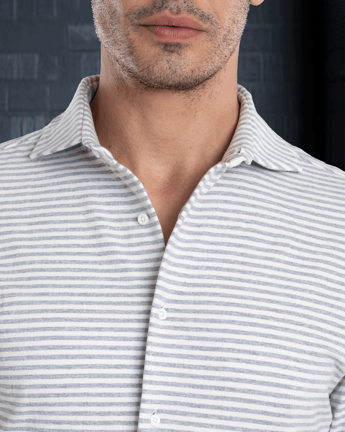 Model wearing custom wool Chino pants for men by Luxire in black wearing collar shirt