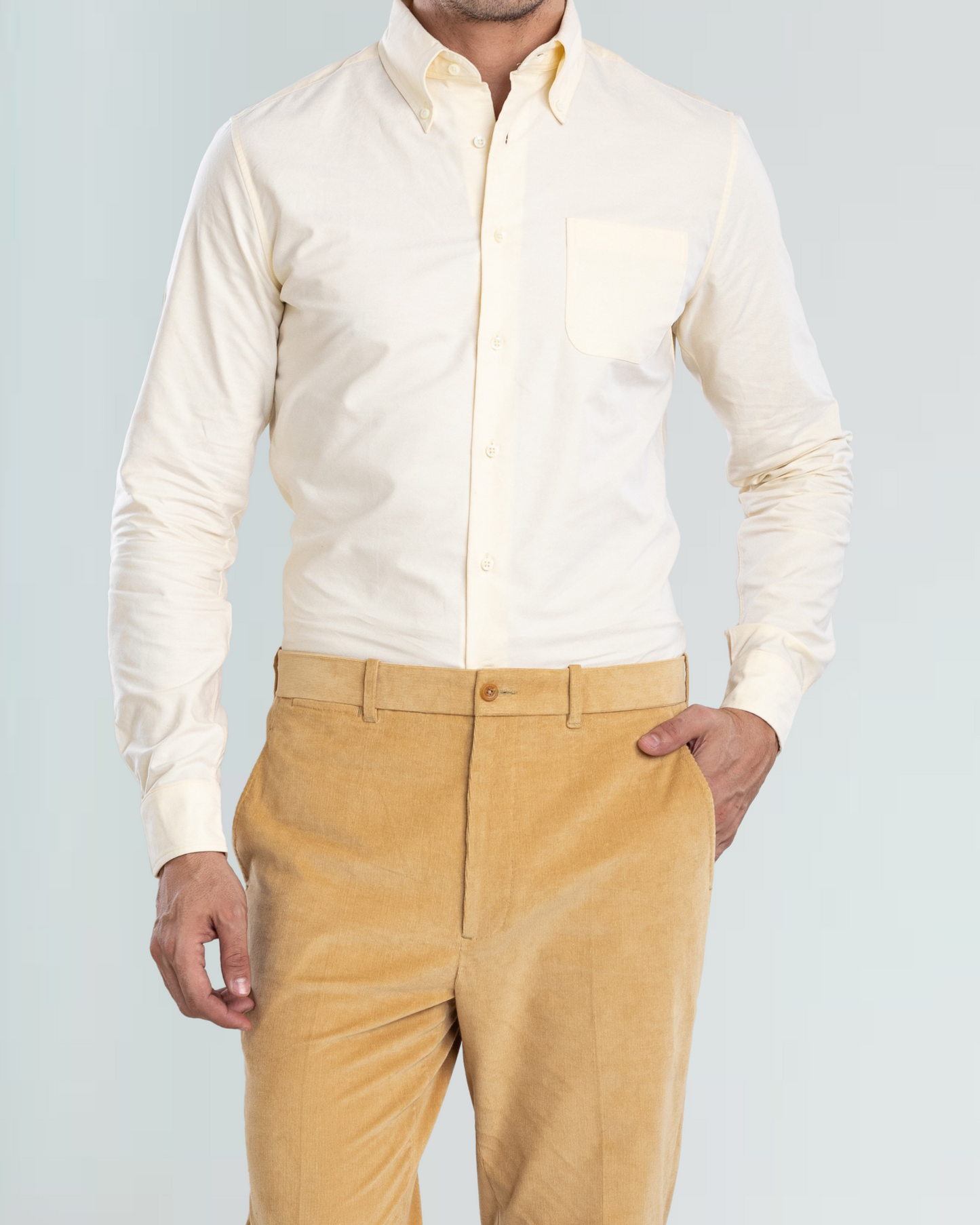 Model wearing the custom oxford shirt for men by Luxire in pale yellow hand in pocket 3