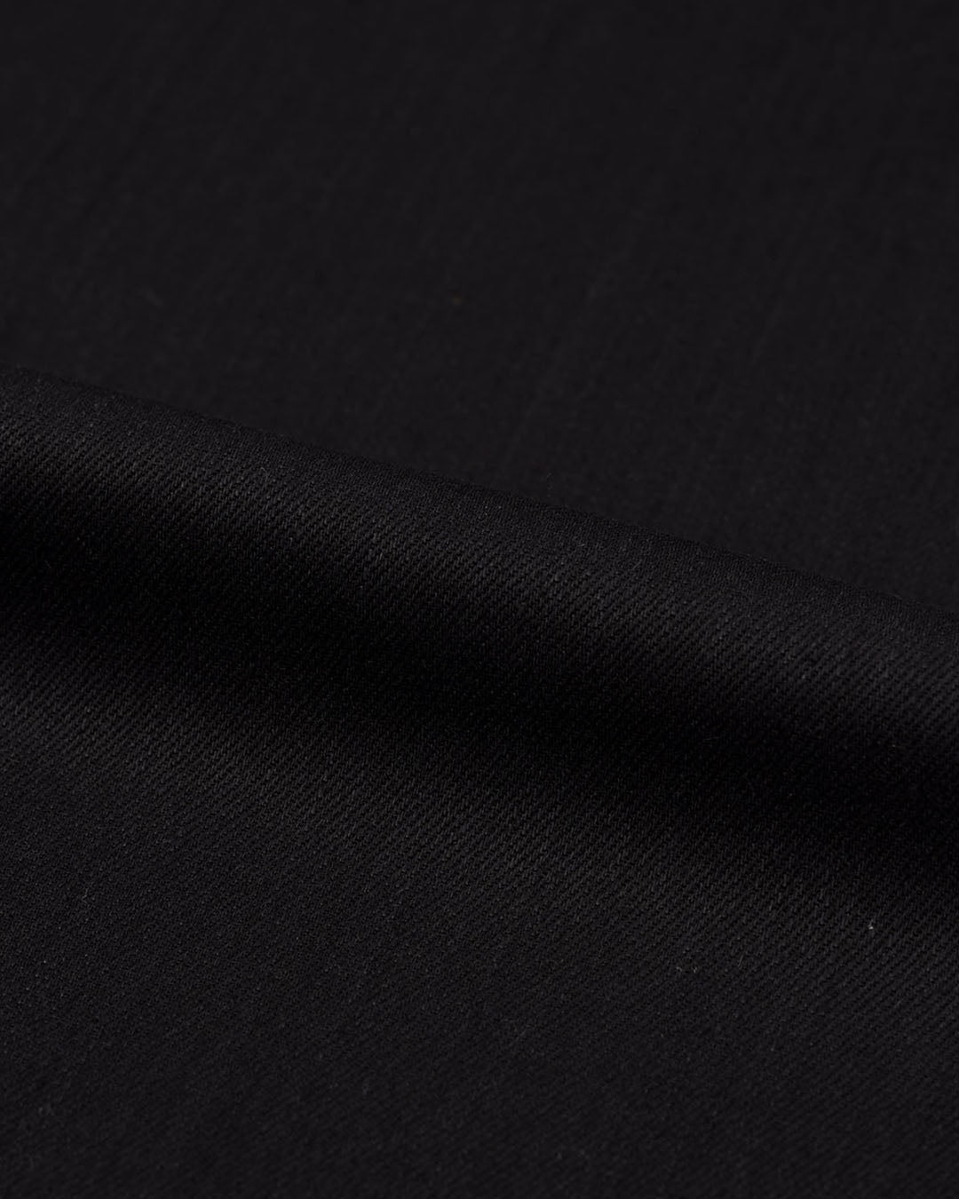 Close up view of stretch denim jeans for men by Luxire in black 3