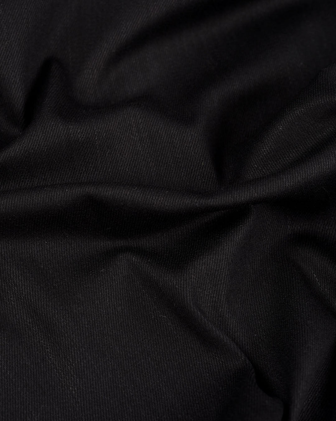 Close up view of stretch denim jeans for men by Luxire in black 2