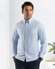 Close up of model wearing the custom oxford shirt for men by Luxire in sky blue hands in pockets
