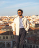Model outside wearing the linen shirt jacket for men by Luxire in cream wearing sunglasses 9